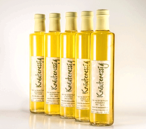 기다란 병에 노란 식초가 가득한 식초병이 나란히 세워졌다.