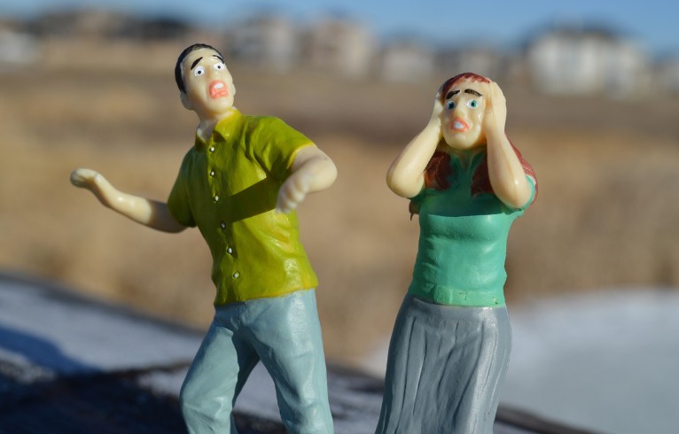 a male and female doll with frightened expression