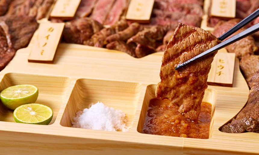 소스에 소고기를 찍고 있다.