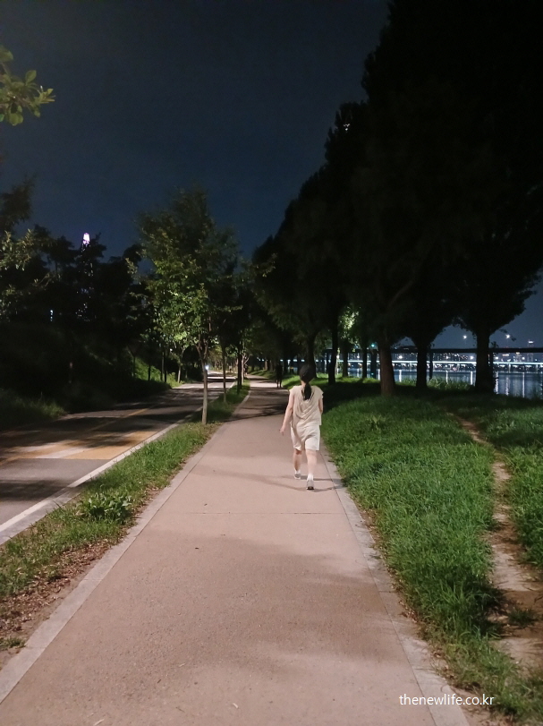 밤 산책길을 걷는 여성 &ndash; 극단적 저염식 상태에서 운동할 경우 발생할 수 있는 소금 부족 증상 연관 장면