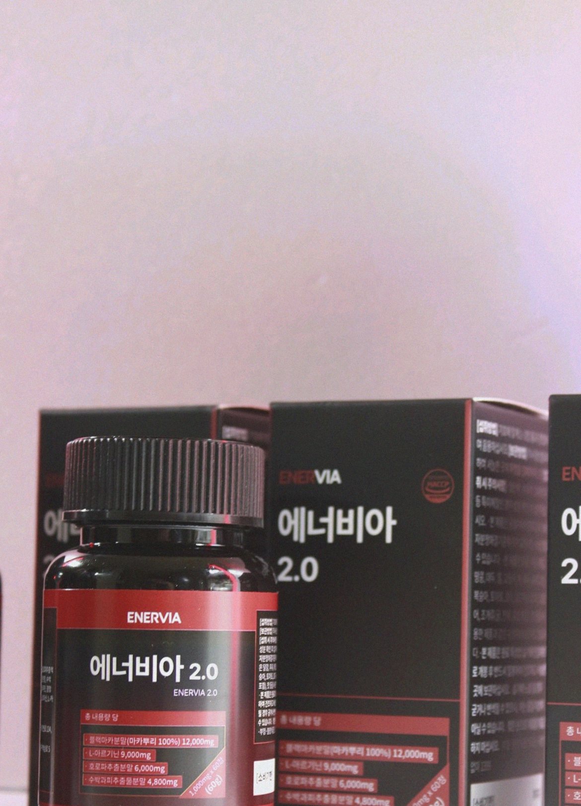 Korean Asian man 37 years old relaxed at home evening holding supplement bottle