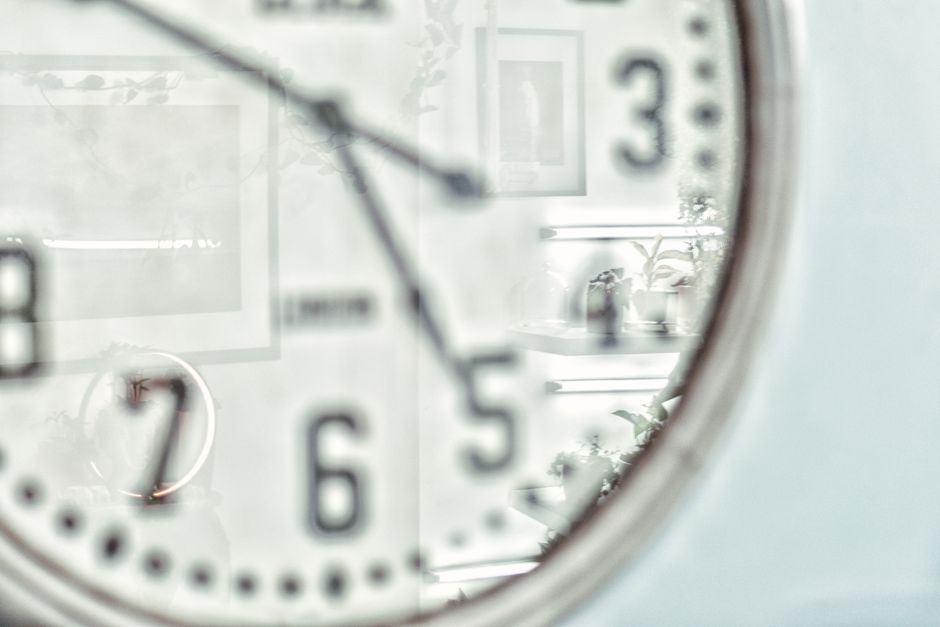 Vintage wall clock with reflection creates an artistic still life impression.