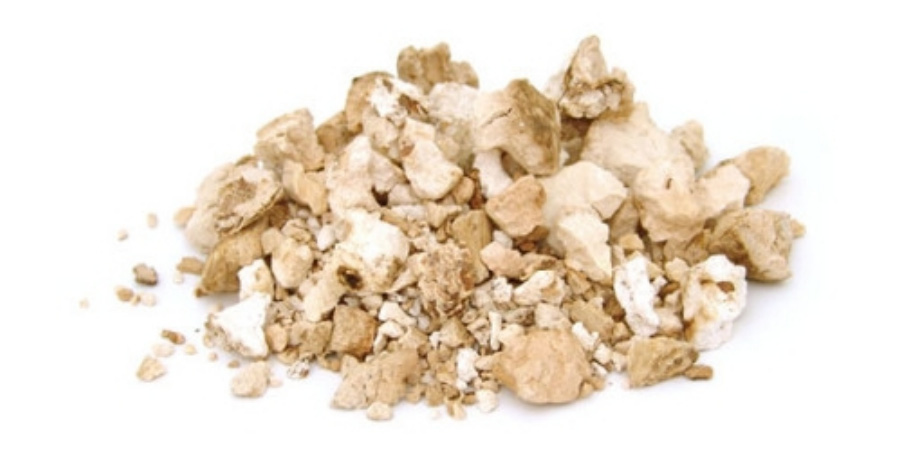 야생에서 채취를 한 백복신을 흰색바닥에 으깨서 덩어리를 쪼갠 후에 쌓아 두고 찍은 사진