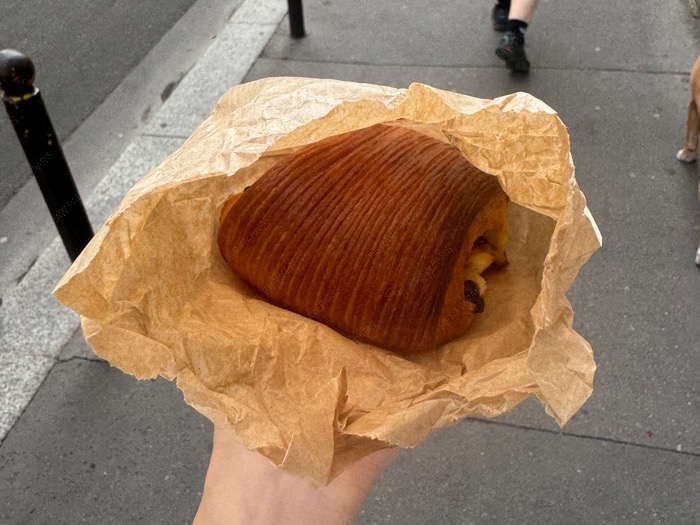 Pain suisse in brown paper bag from MOBO bakery Paris