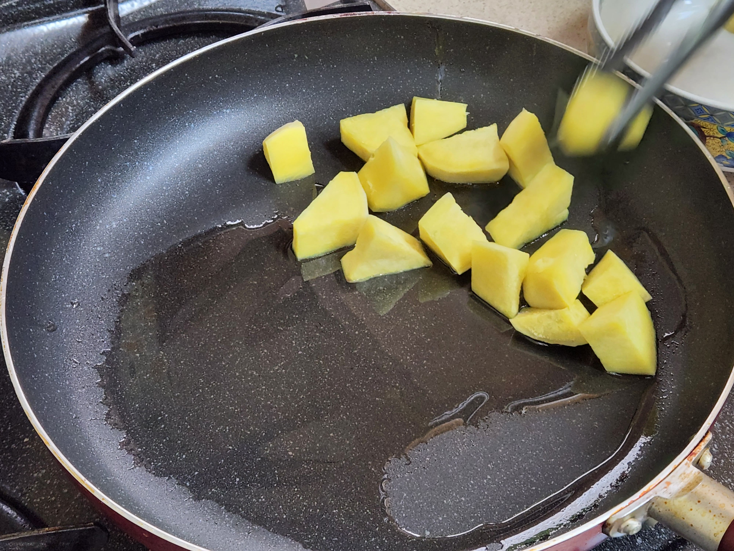 프라이팬에 반틈 익은 고구마를 넣기