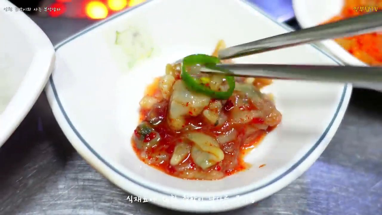 매콤하게 무친 반찬을 젓가락으로 든 모습