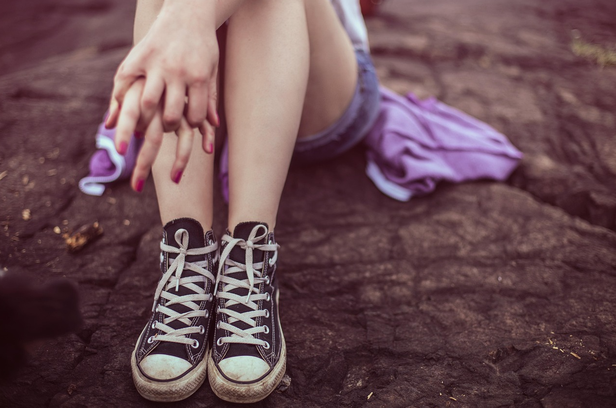 한 여성이 바위 위에 홀로 앉아 있다