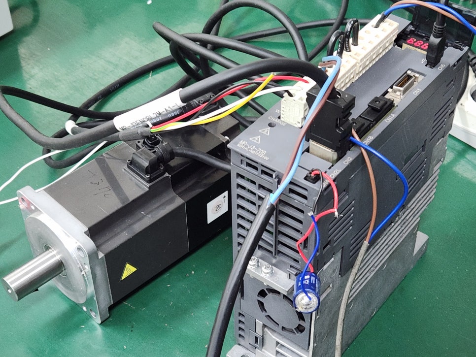 미쓰비시(MITSUBISHI) 서보드라이버 MR-J3-70B 제어 회로 내 엔코더 신호 처리 소자의 열화 및 통신 라인 불안정이 확인.
불량 소자 교체 및 통신 회로 안정화 작업을 거쳐 완벽하게 수리 완료.
수리 과정 by 메트영남