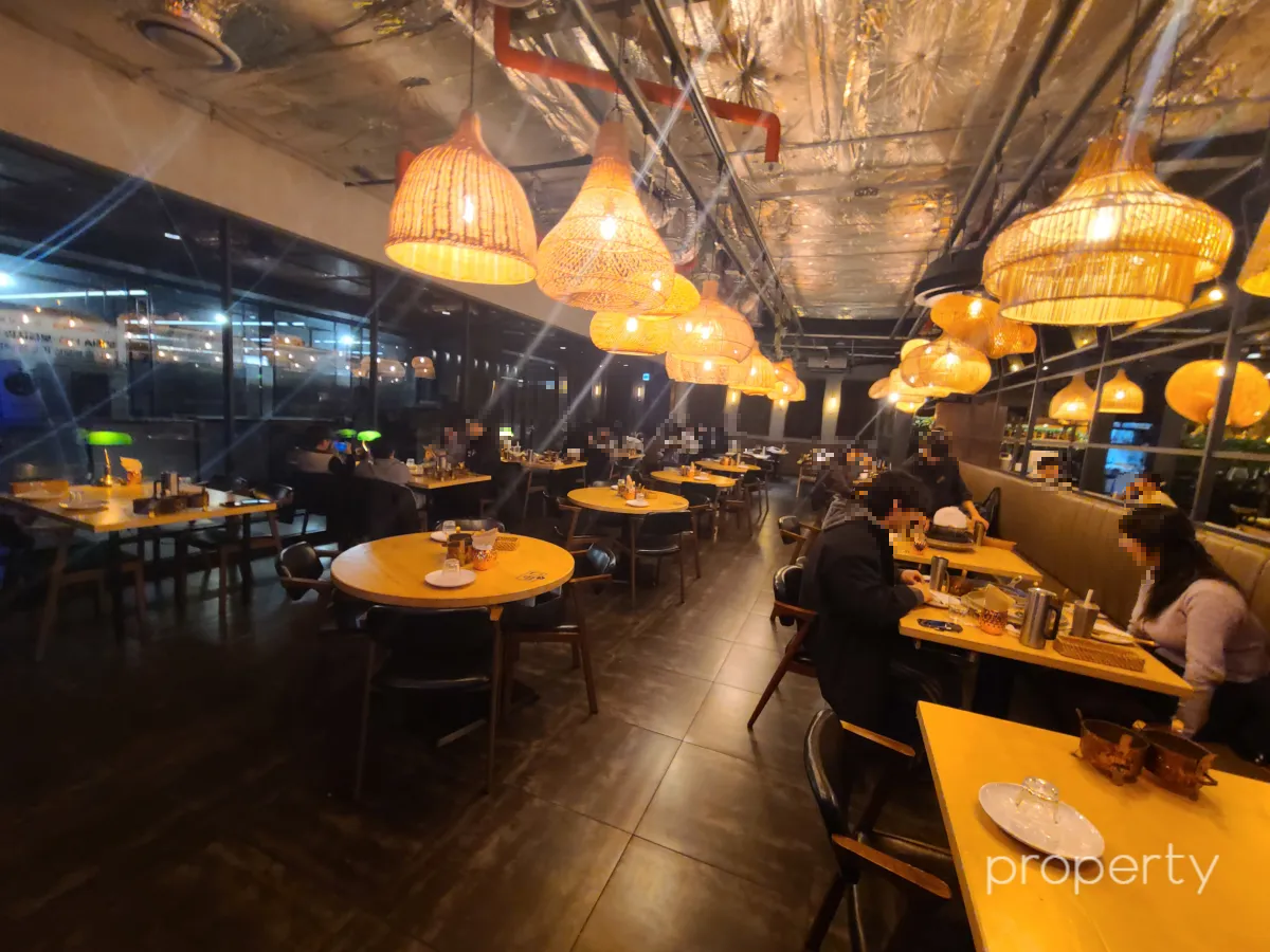 아그라용산내부-테이블이많은-테이블마다있는라탄조명의반짝임-밥먹는사람들