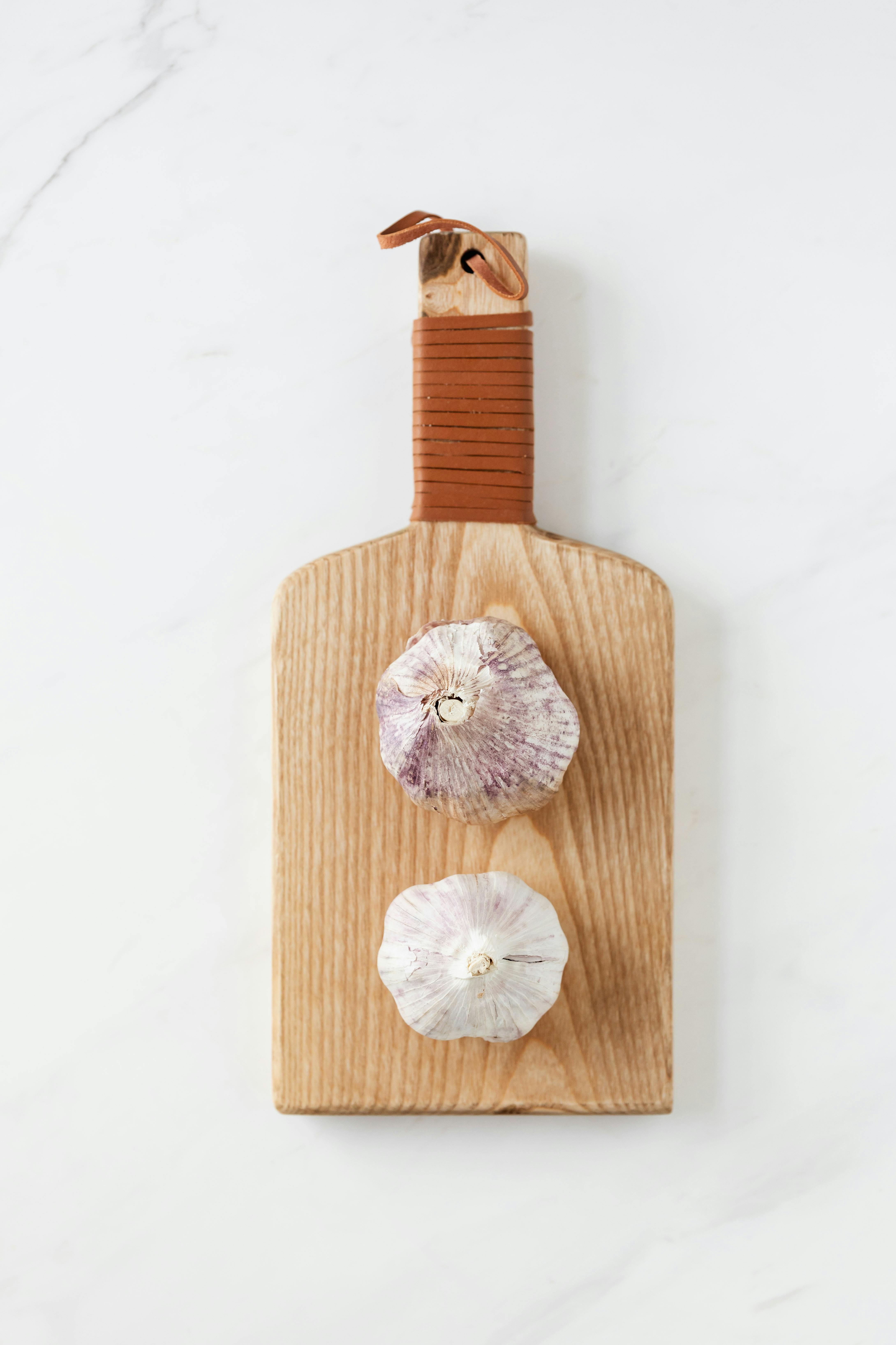 Fresh garlic bulbs and cloves on a wooden cutting board &mdash; symbolizing how garlic is an essential ingredient in everyday Korean cooking.
