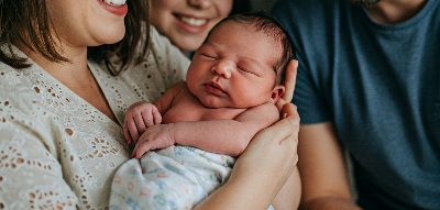 가족이 태어난 아기를 축복하며 행복해 하는 사진