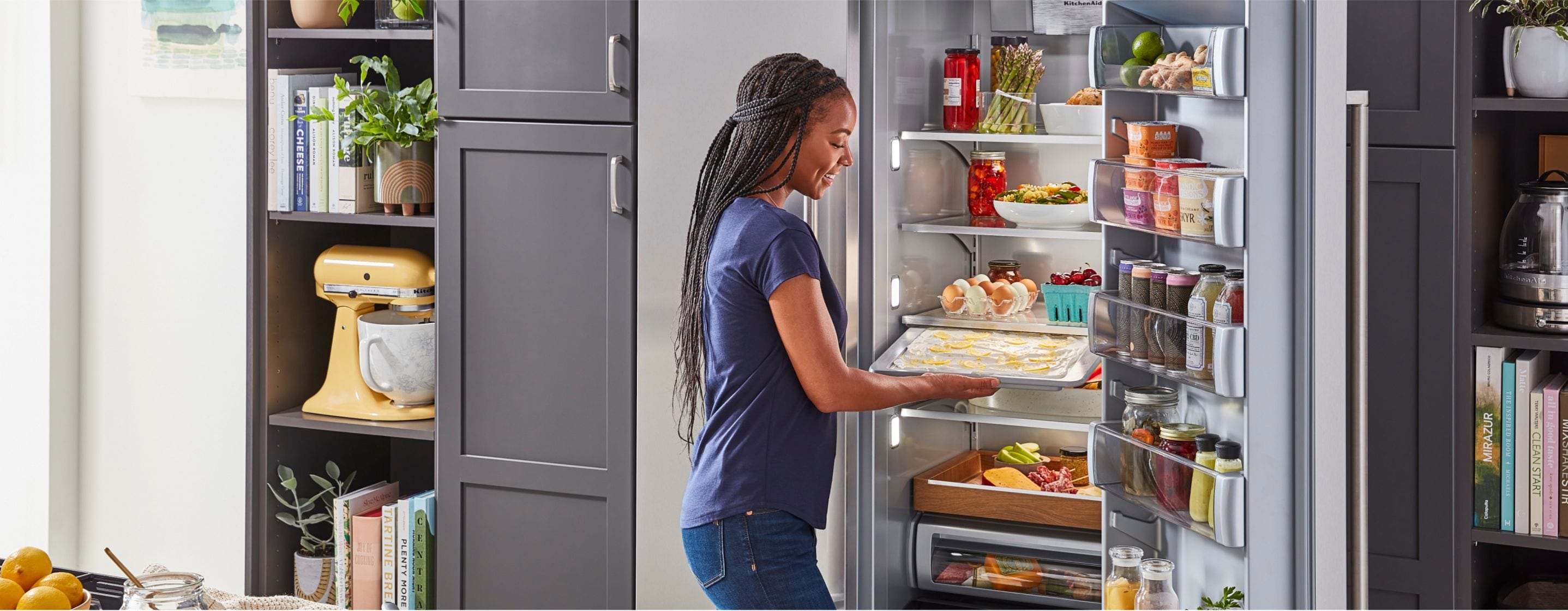 Various refrigerator models displayed in a modern kitchen, emphasizing features and a checklist for buying guide.