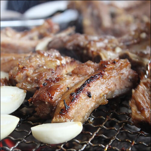 갈비와 마늘이 불판 위에 있는 모습