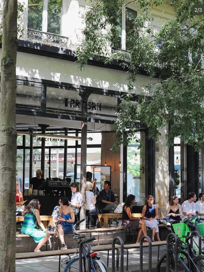 Spacious industrial style interior of Partisan Cafe in Paris with metal and wood details⁠