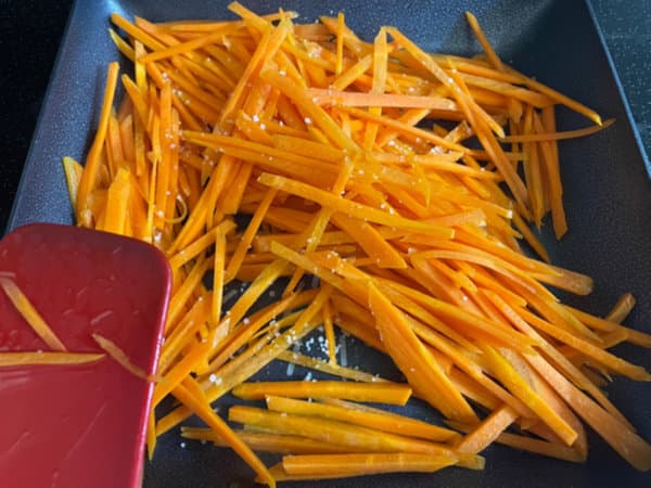 Stir-frying the carrot matchsticks for kimbap filling