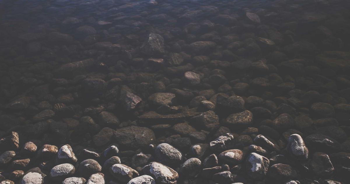 A person relaxing in a modern smart home living room, surrounded by smart devices