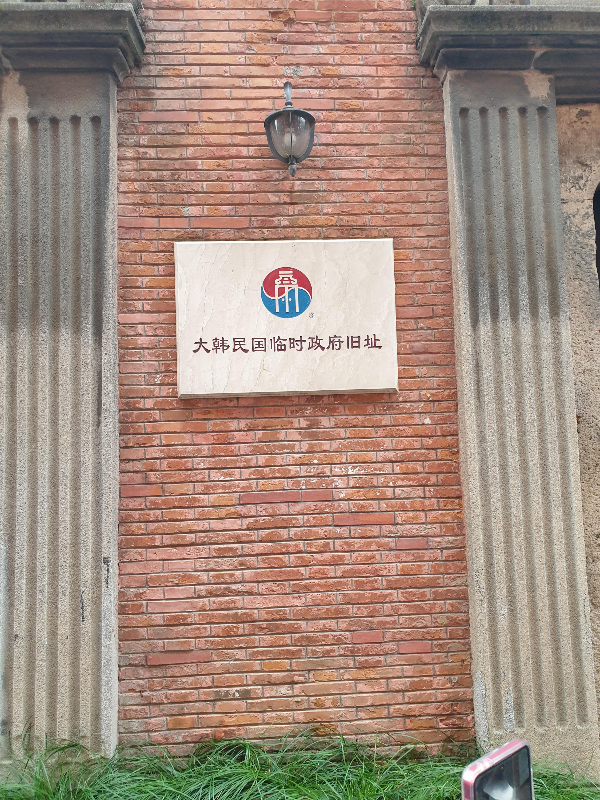 회색 기둥에 적색 벽돌로 이뤄진 포토존. 작은 대한민국임시정부 유적지 간판이 보인다.