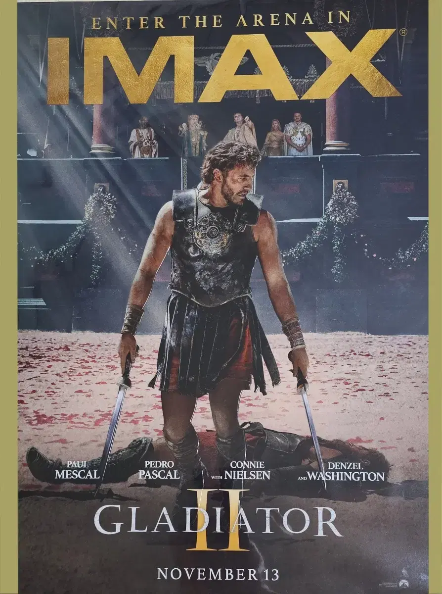 고대 로마제국의 갑옷을 입은 한 남자가 양 손에 칼을 들고 서 있는 모습의 영화 'Gladiator(글래디에이터)2' 포스터