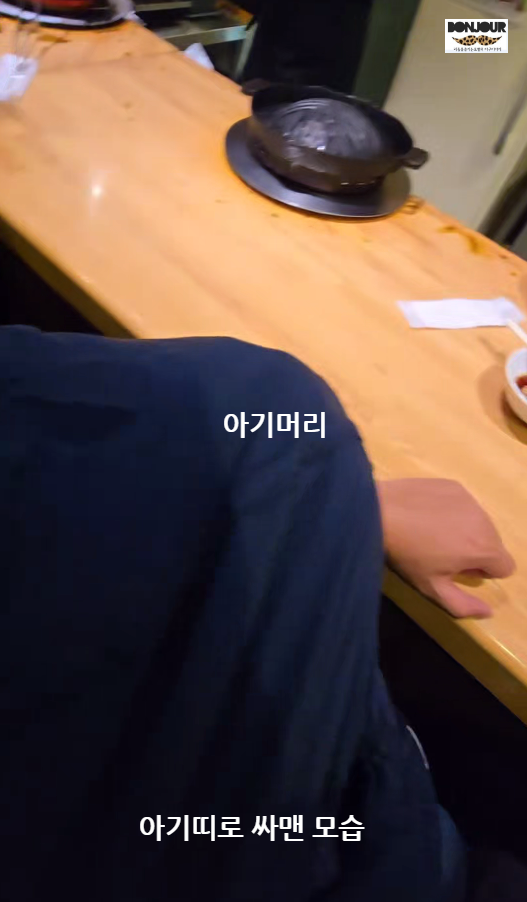 다루마 6.4에서 아기띠로 아기를 매고 천으로 덮어두고 식사를 하고 있다.