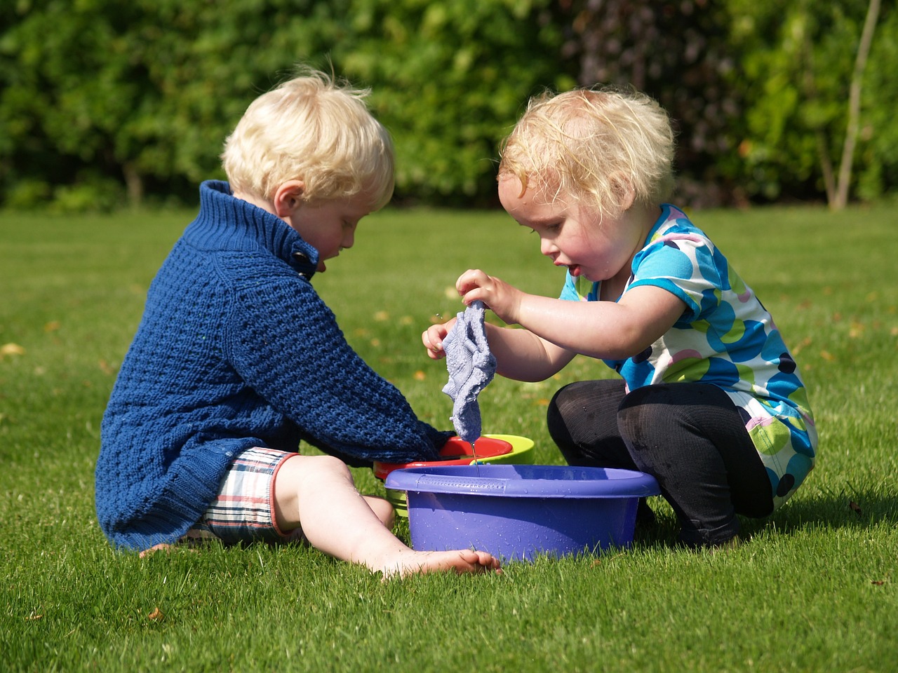 Two little kids helping each other