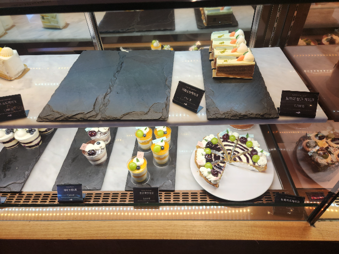 The carrot cake is in the display case.