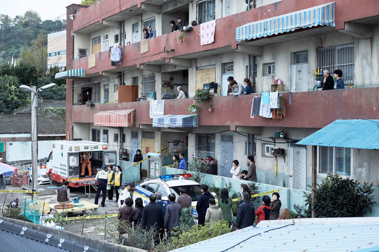 아리동 맨션 앞에 구급차와 경찰차가 와 있는 모습