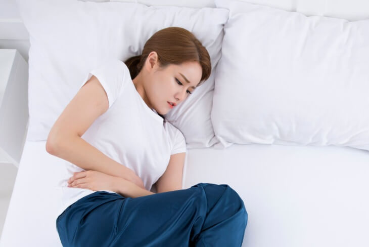 속이-불편해-누워있는-사람