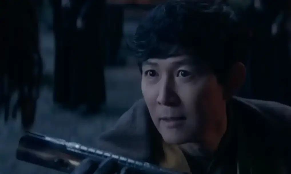 젊은 모습의 이정재가 광선검 자루를 들고 누군가에게 미소지으며 주는 모습