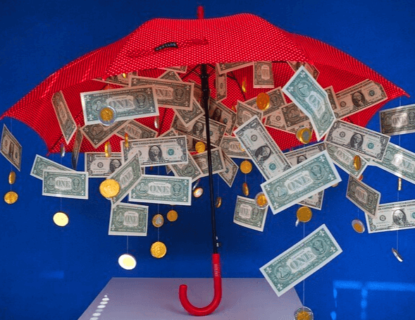 빨간 우산에서 달러 지폐들이 수없이 쏟아지는 모습이다.