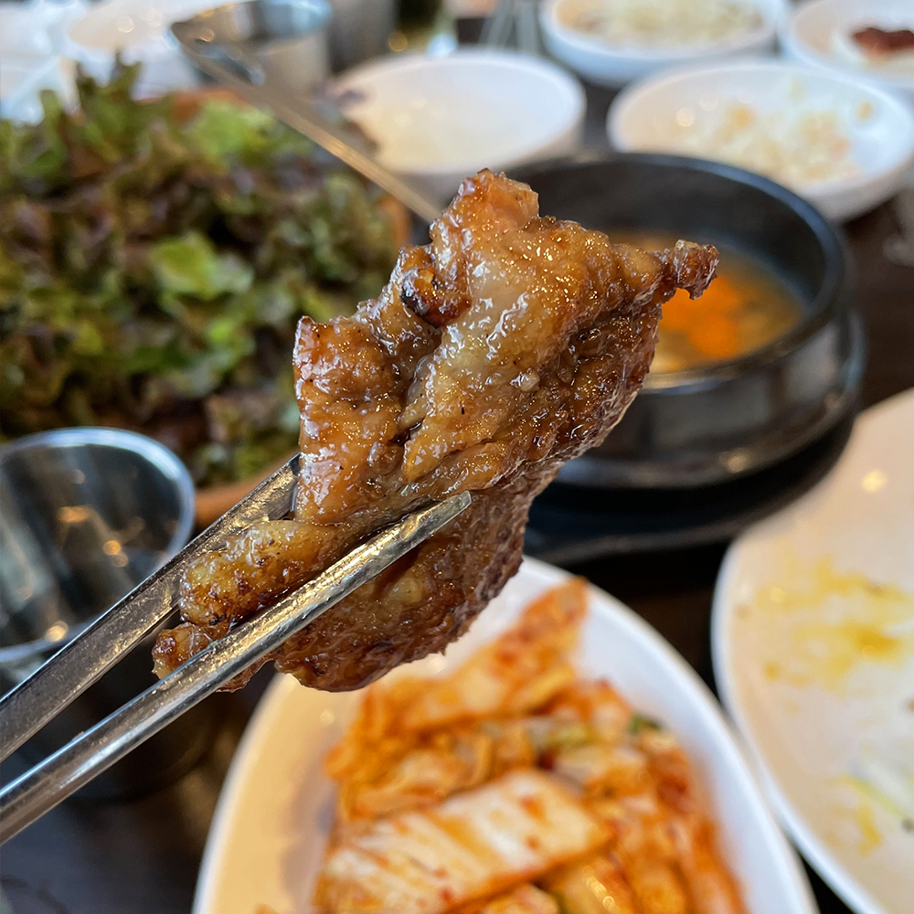 잘게-썬-돼지갈비-한-점을-젓가락으로-집고-있습니다.