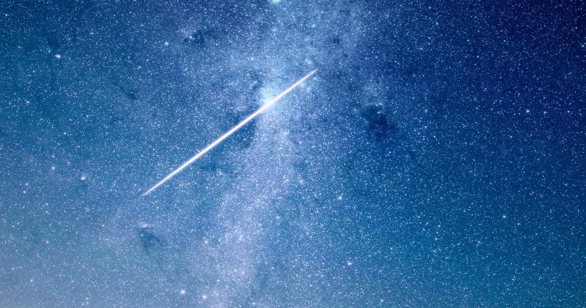 futuristic living room with smart devices, person interacting with a smart speaker, glowing smart lights