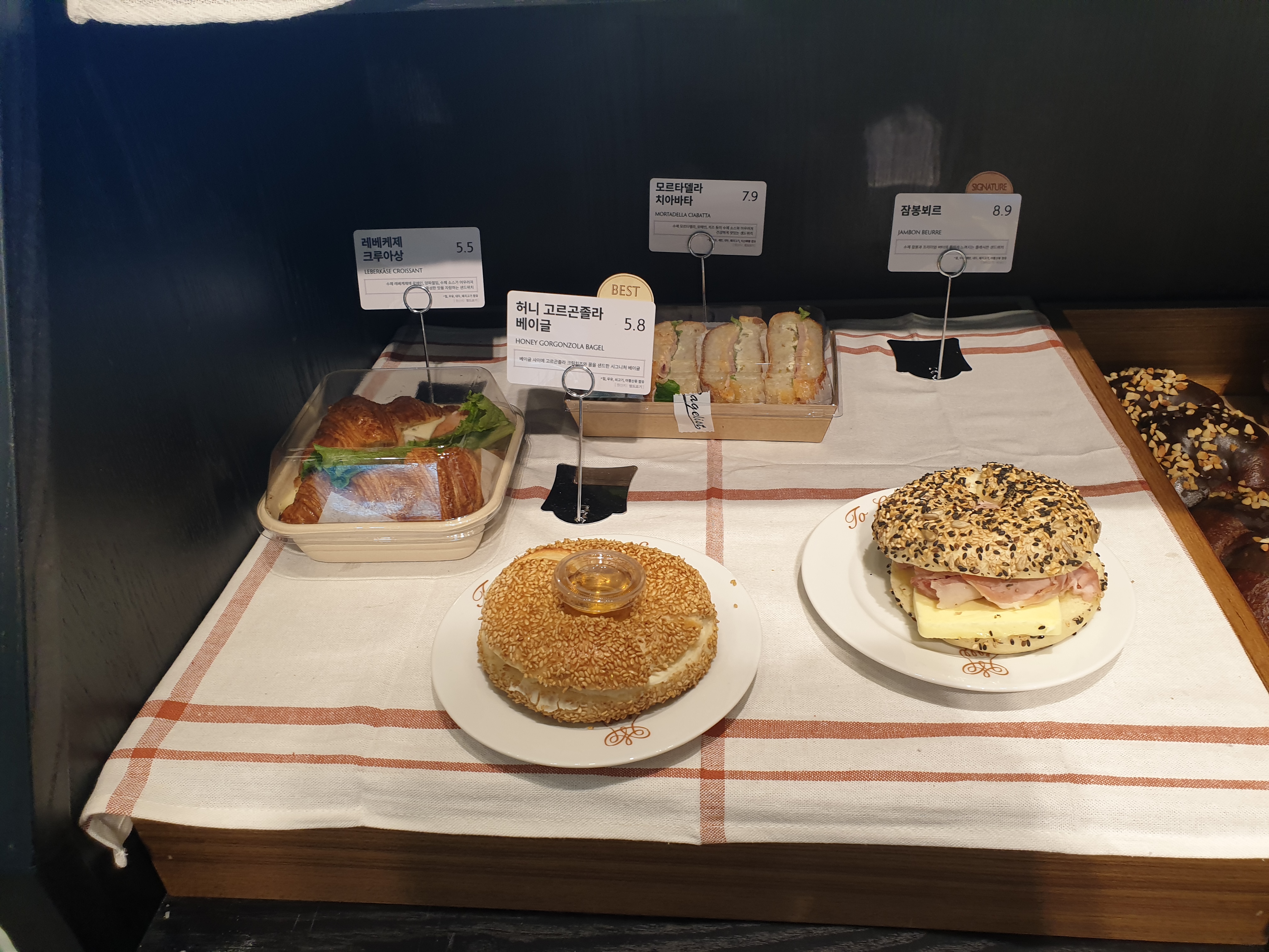 4종의 베이글 및 샌드위치가 진열되어 있다.