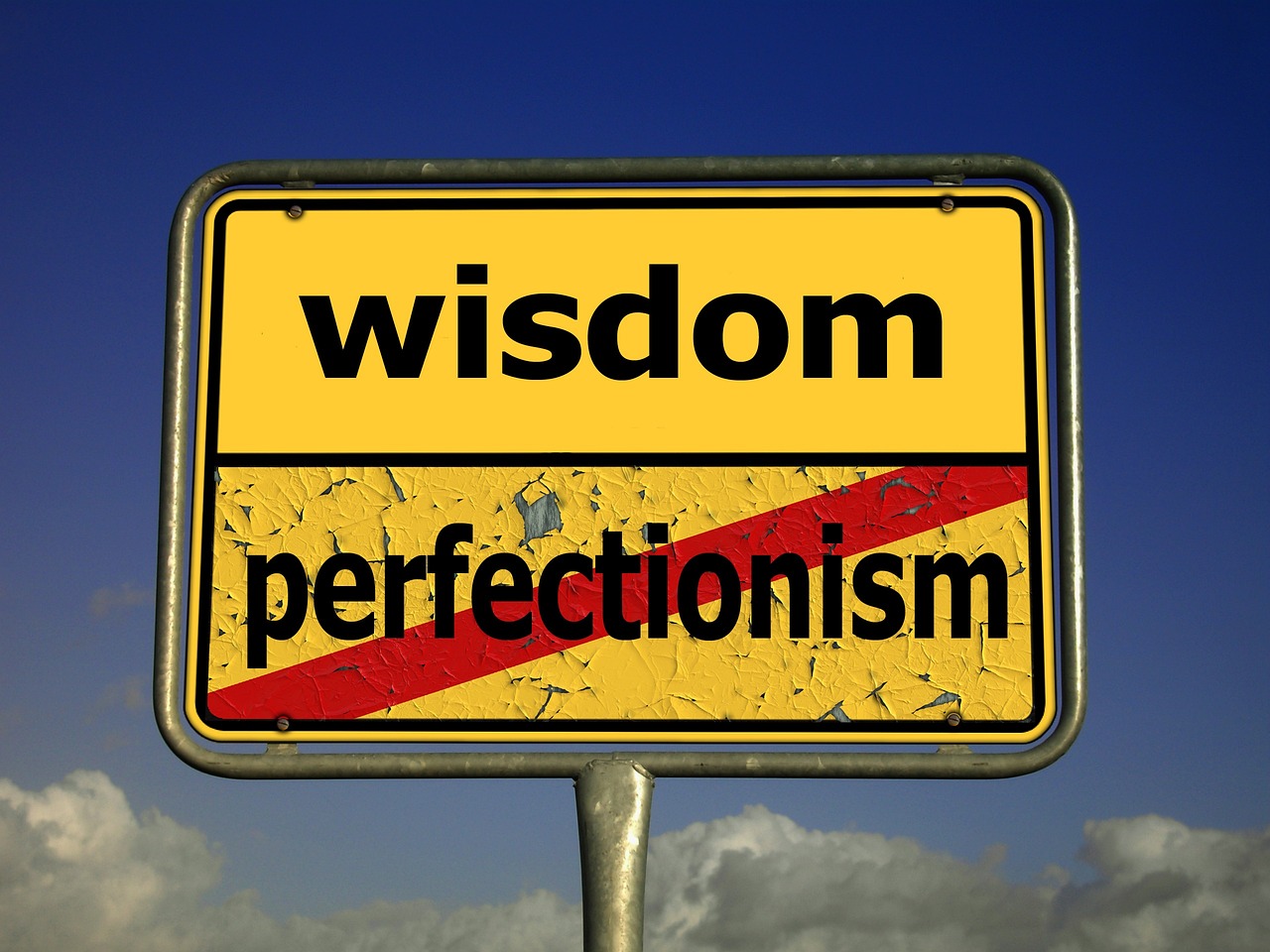 표지판에 wisdom 강조, perfectionism은 빨간 줄로 지워져 있는 모습