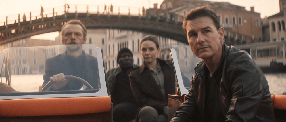 Mission Impossible main characters Ethan Hunt Benji Luther and Ilsa are sailing through a canal.