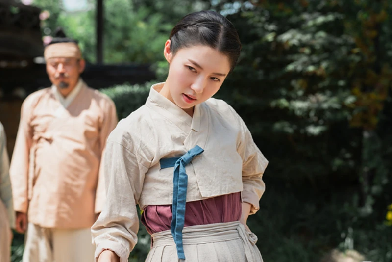 조선을 배경으로 하인복을 입고 주걱을 들고 서 있는 드라마 열녀박씨 계약결혼뎐의 사월