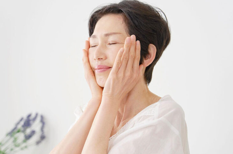 얼굴을 만지는 여성